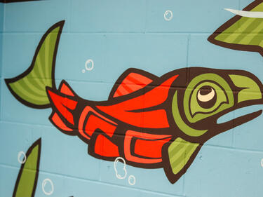 Painted mural of Indigenous art of a salmon