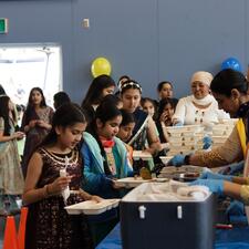 Students in line, receiving their food from the PAC